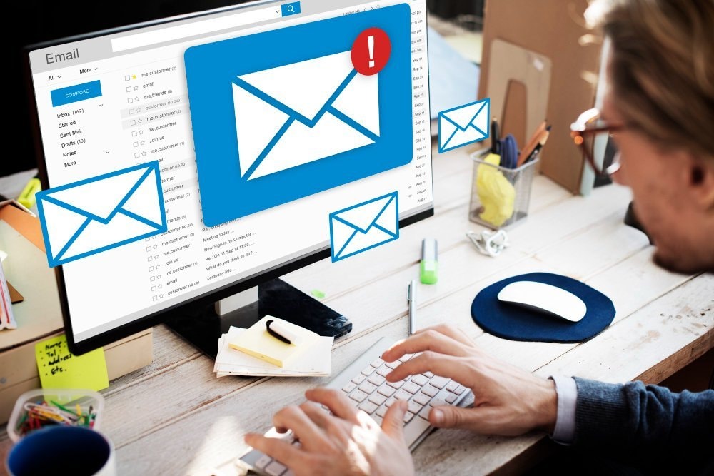 Marketer checking email campaign open rates on a laptop